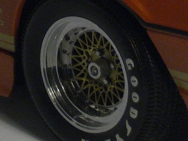 Close-up of a toy car wheel and tire.