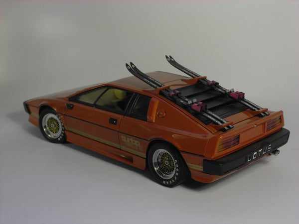 Orange Lotus sports car scale model with ski rack.