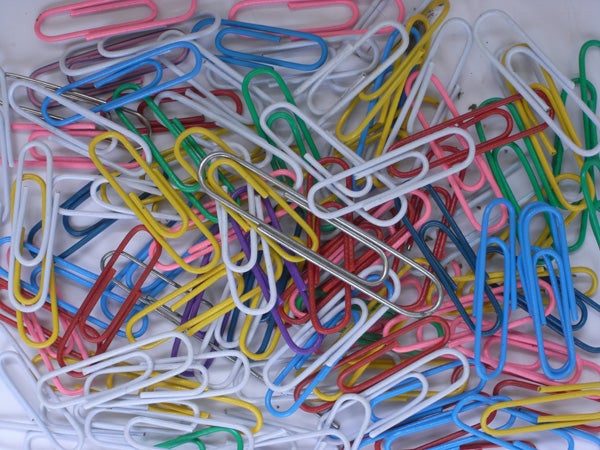 Close-up of colorful paper clips on a white background.