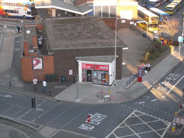 Bird's-eye view of a street corner and convenience store.
