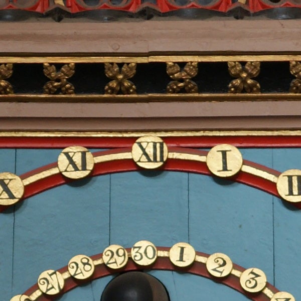 Decorative clock face with Roman numerals.