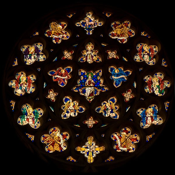 Stained glass window detail with intricate designs and vibrant colors.