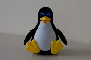 Tux Droid toy on a white background.
