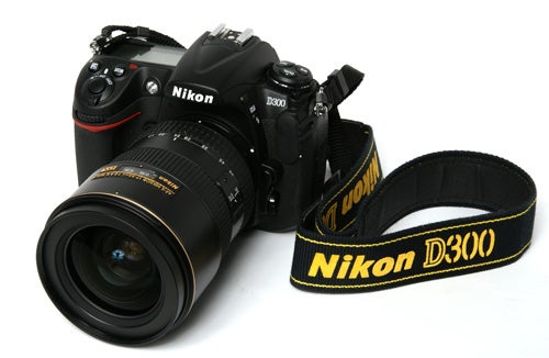 Nikon D300 DSLR camera with zoom lens and strap.