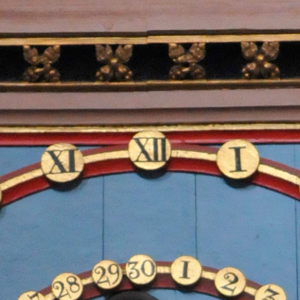Close-up photo of ornate clock face details.