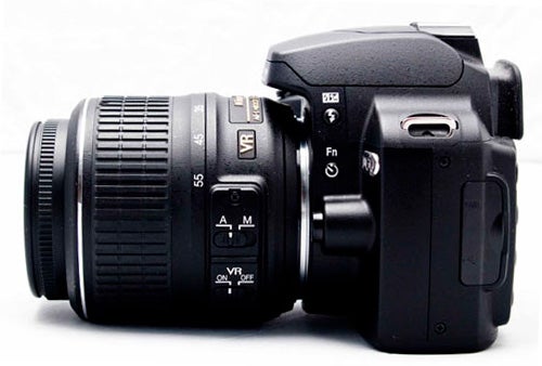 Nikon D60 DSLR camera with attached lens on white background.
