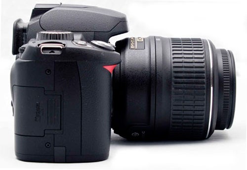 Nikon D60 DSLR camera with attached lens on white background