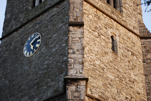 Photo of an ancient stone tower with a blue clock.Sharp photo of an old clock tower taken with Nikon D60.