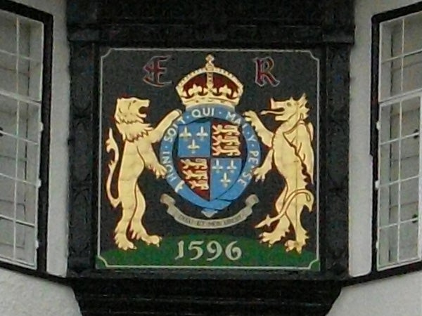 Colorful heraldic crest on a building photographed in 1596 resolutionCoat of arms on a building wall with the date 1596