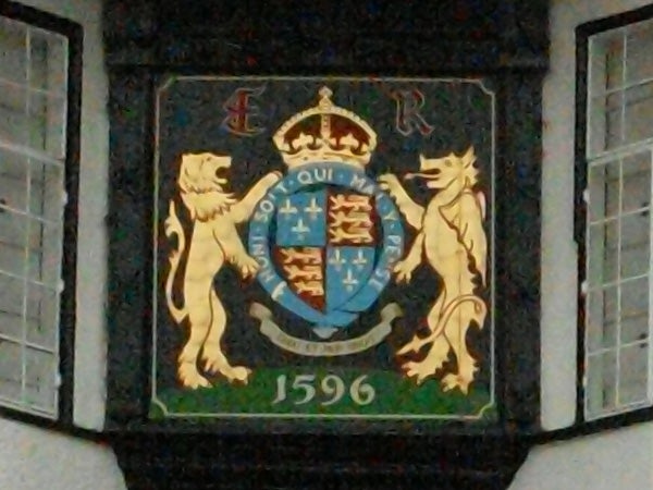 Coat of arms plaque with two lions and a crown dated 1596.Image of a colorful heraldic crest with lions and a crown, dated 1596.