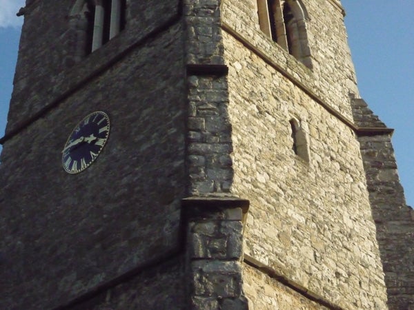 Photo of an old church tower with a clock.Photograph of a church tower with a clock taken with Panasonic Lumix DMC-FS5.