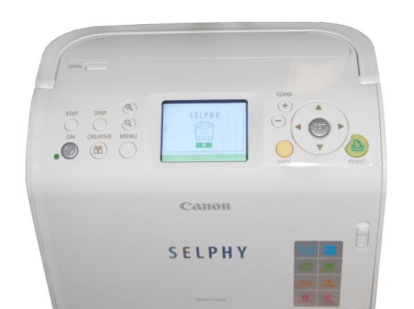 Close-up of Canon Selphy ES20 compact photo printer.Close-up of Canon Selphy ES20 compact photo printer controls.