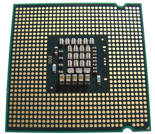 Intel Core 2 Duo E8500 processor's underside with gold contact pins.Intel Core 2 Duo E8500 processor with visible pins.