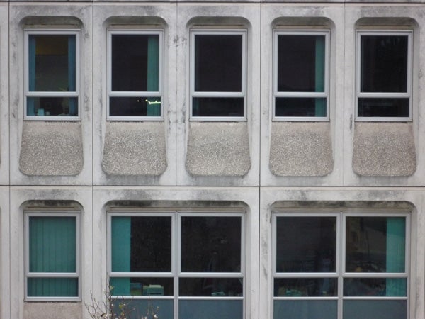Photograph of a building facade with patterned windows.Concrete building facade with patterned windows