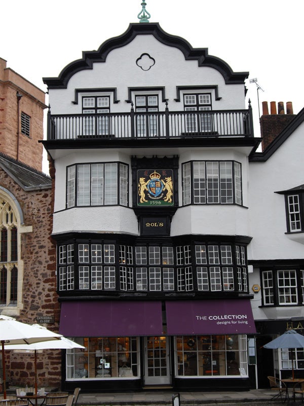 Historic building facade with coat of arms, dated 1596.Historic black and white building with a coat of arms