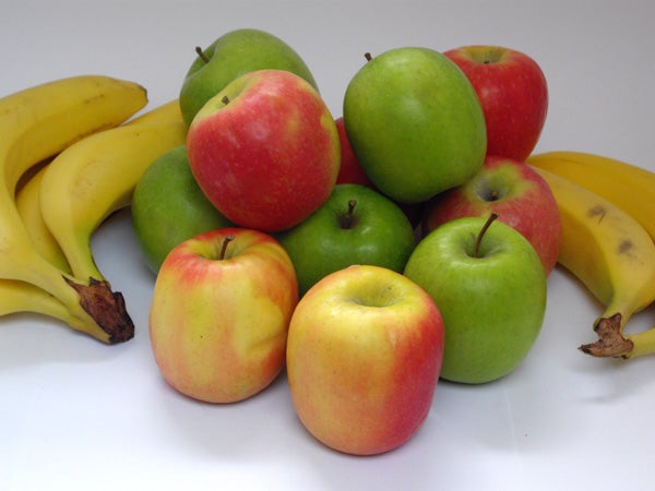 Colorful apples and bananas arranged on a white background.Photo of apples and bananas on white background.