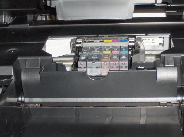 Close-up of Canon PIXMA MX850 printer's ink cartridges and control panel.Canon PIXMA MX850 printer's open interior showing ink cartridges.