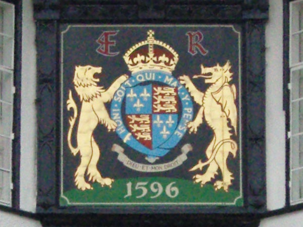 Coat of arms plaque with crown, lions, and date 1596.Emblem with lions and a crown, timestamped 1596
