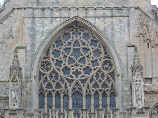 Intricate stone archway of a historic cathedral.Ornate gothic church window architecture detail