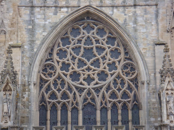 Intricate gothic window architecture of a cathedral.Intricate gothic window architecture on a stone building facade.