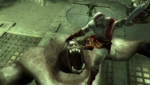 God of War: Chains of Olympus gameplay screenshot.God of War character fighting a mythical monster in-game.