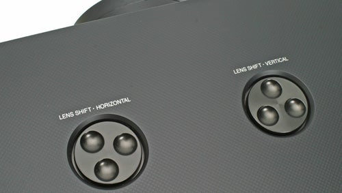 Close-up of Panasonic projector's lens shift controlsClose-up of Panasonic projector's lens shift controls.