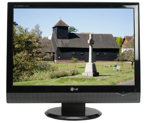 LG Flatron M228WD 22-inch monitor displaying a landscape scene.