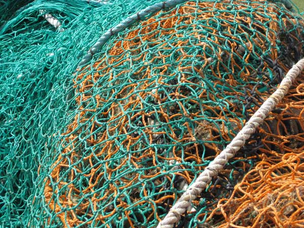Colorful tangled fishing nets and ropes.Colorful fishing nets and ropes piled up.