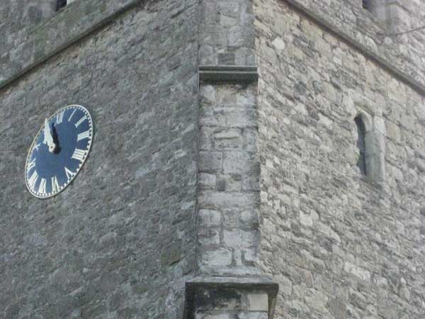 Photo taken with Canon IXUS 80 IS showing a church clock tower.Photograph of an old church tower with a clock