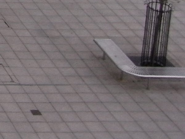 photo of an outdoor bench and pavementimage of a bench on tiled pavement.
