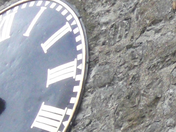 Close-up of a clock face against a rocky background.Close-up of a wristwatch face against a rocky background.