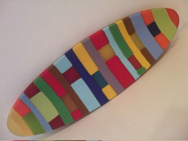 Colorful abstract surfboard-shaped artwork.