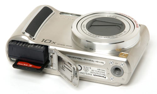 Panasonic Lumix DMC-TZ4 camera with open battery compartment.