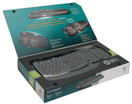 Logitech Wave Keyboard in open packaging with product information.Logitech Wave Keyboard in open packaging with features displayed.