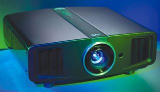 JVC DLA-HD100 HD D-ILA projector illuminated in blue light.