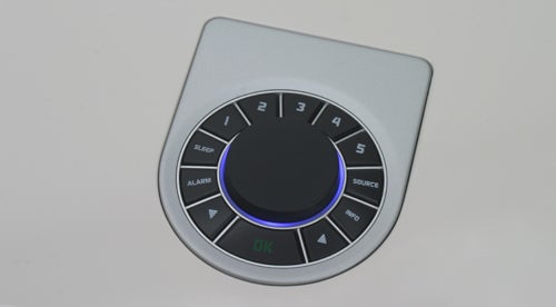 Close-up of Vita Audio R2's control interface with illuminated blue ring.Vita Audio R2 control interface with illuminated buttons.