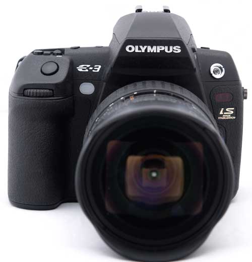 Olympus E-3 DSLR camera with lens attached.Olympus E-3 DSLR camera with lens facing forward.