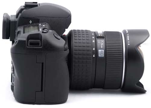 Olympus E-3 Digital SLR camera with zoom lens attached.Olympus E-3 DSLR camera with lens and hood.