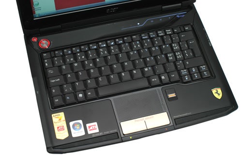 Acer Ferrari 1100 laptop with distinctive logo and black keyboard.Acer Ferrari 1100 laptop with distinctive branding and keyboard.
