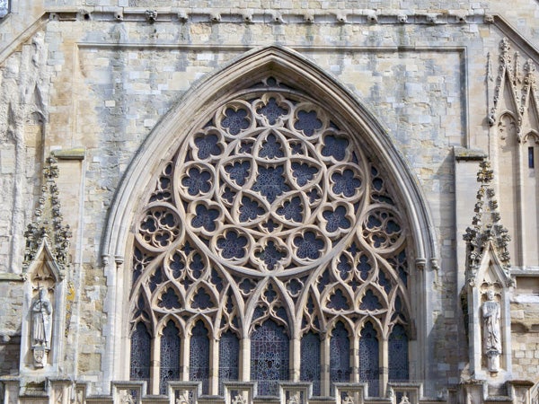 Intricate stone window design on a Gothic cathedral facade.Detailed architecture of a Gothic church window.