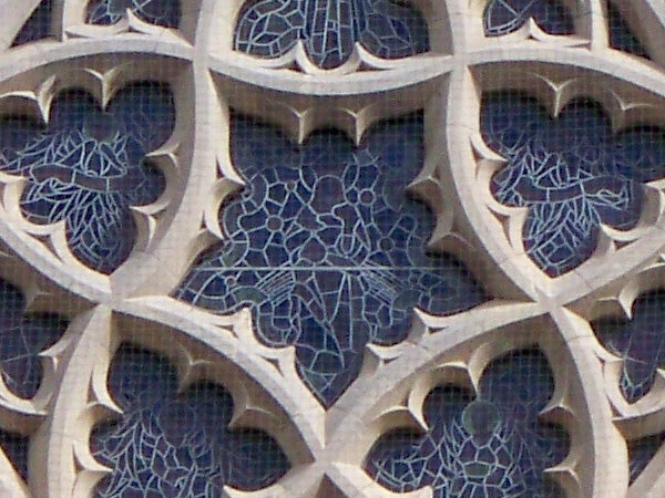 Close-up of intricate stone gothic window tracery.Detailed gothic window tracery pattern.