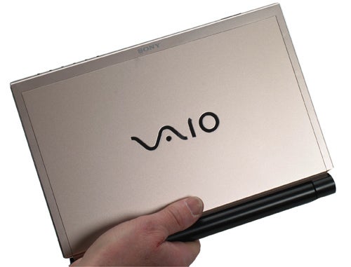 Hand holding a closed Sony VAIO VGN-TZ31MN notebook.Hand holding a Sony VAIO VGN-TZ31MN notebook.