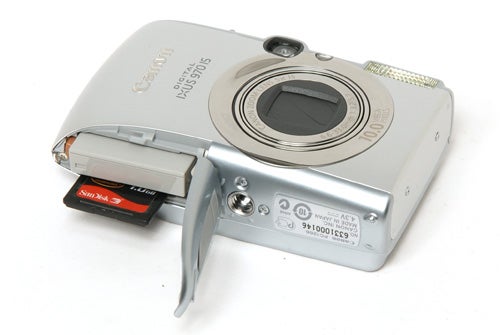 Canon IXUS 970 IS digital camera with memory card slot open.Canon Digital IXUS 970 IS camera with memory card slot open.