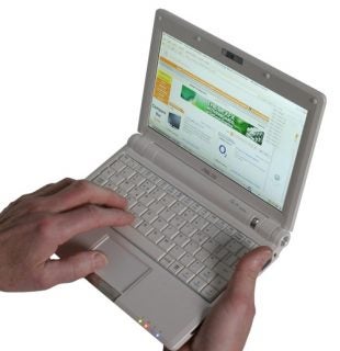 Hands holding an open Asus Eee PC 900 laptop