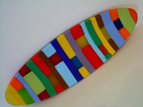 Colorful surfboard on white background.