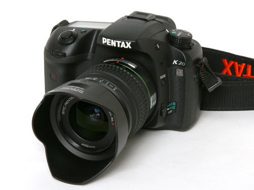 Pentax K20D DSLR camera with lens and strap.
