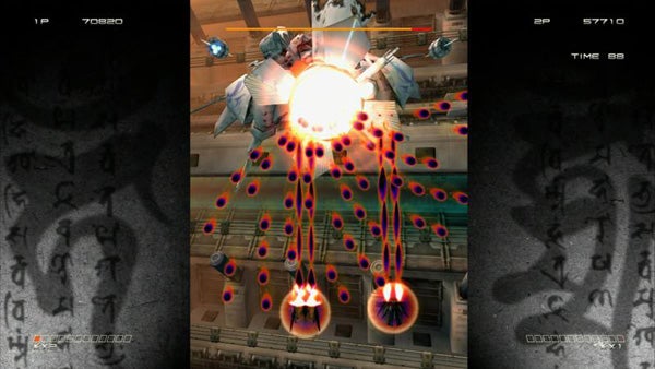 Screenshot of Ikaruga game showing intense bullet-dodging action.