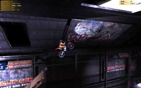 Screenshot from Trials 2: Second Edition game showing motorcycle stunt.Motorcyclist performing a stunt in Trials 2: Second Edition game.