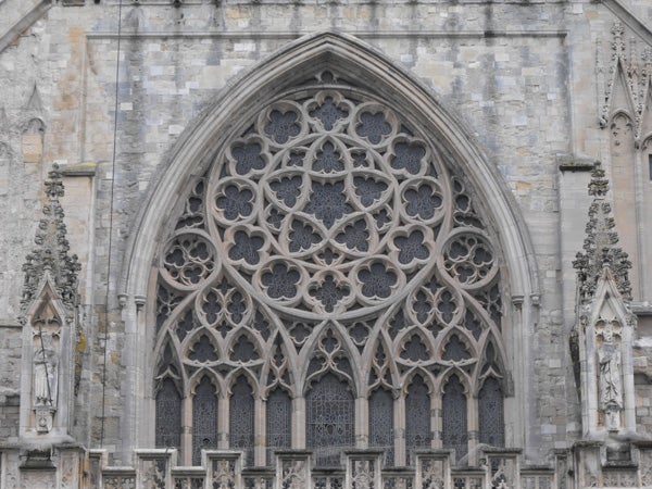 Detailed stone archway of a Gothic cathedral.Close-up of intricate gothic church window tracery.