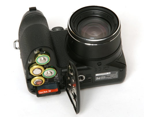Fujifilm FinePix S1000fd camera with open battery compartment.